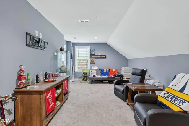a living room with furniture and white walls