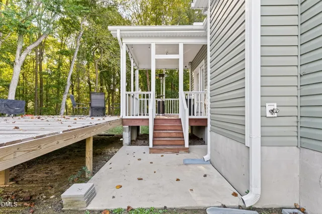 a view of house with backyard and outdoor seating