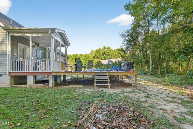 a view of a house with a yard and sitting area