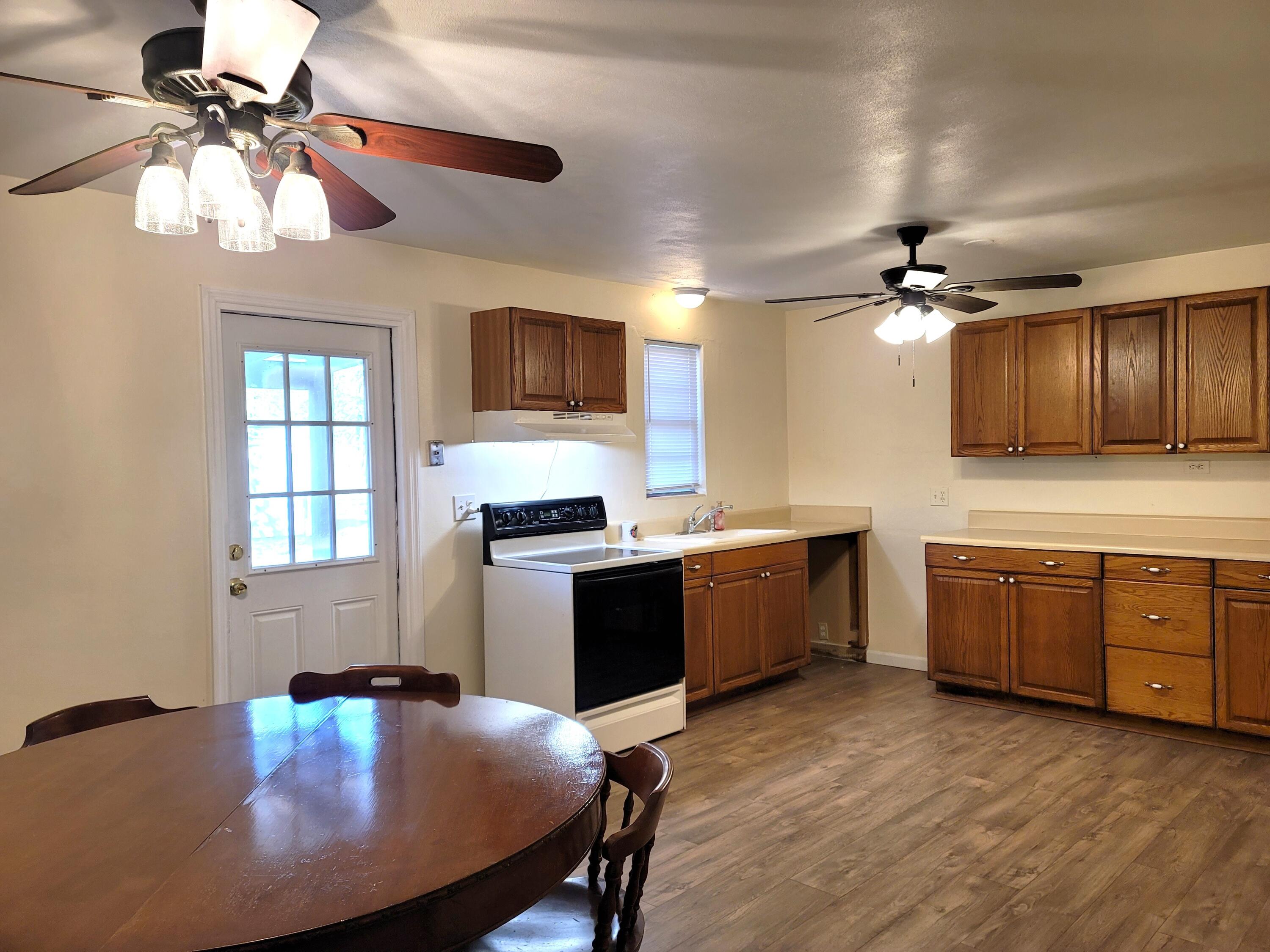 4362 West Midway Road Fort Pierce, FL 34981 - Photo 11 of 31 a kitchen with cabinets a sink and appliances