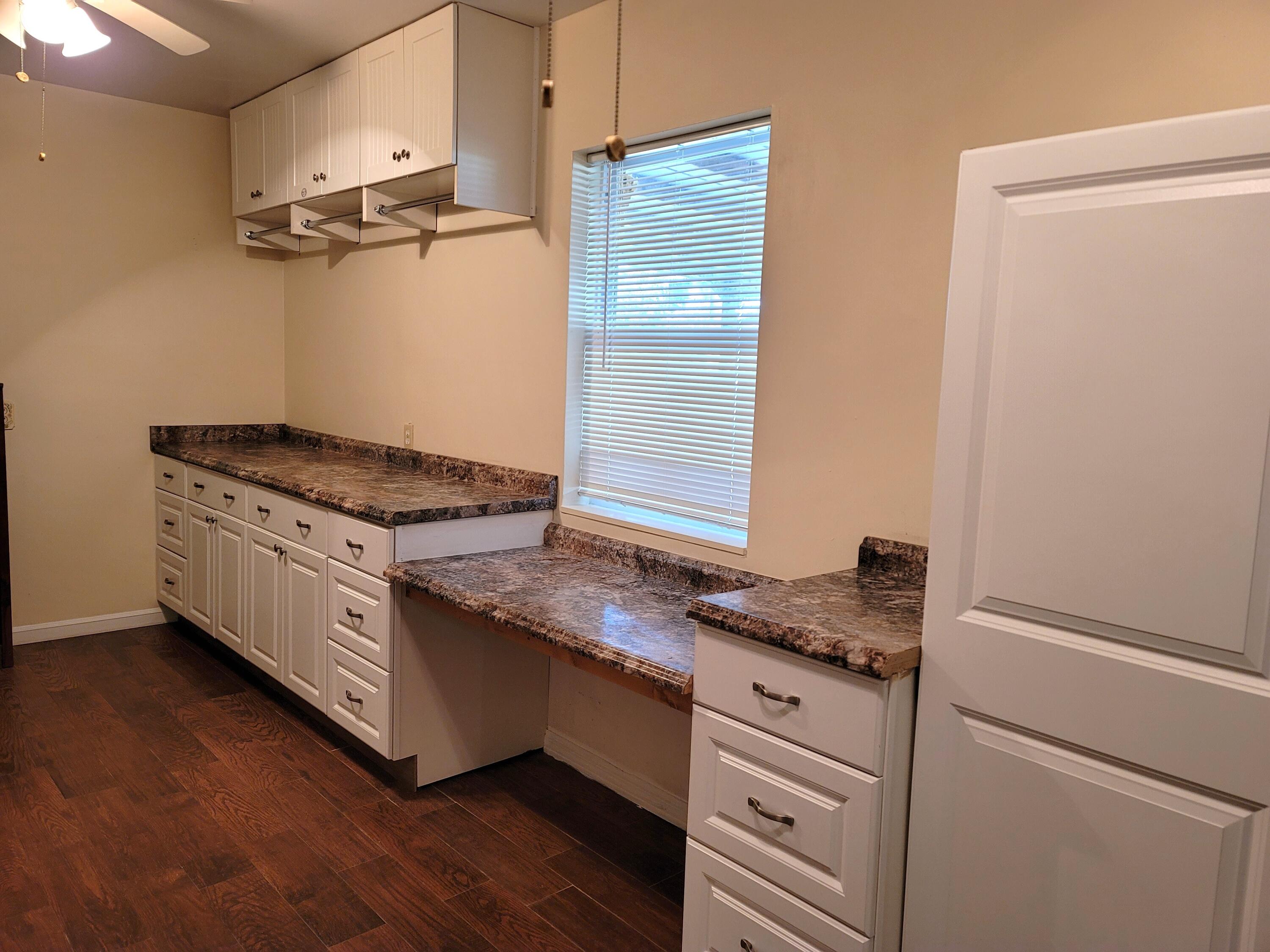 4362 West Midway Road Fort Pierce, FL 34981 - Photo 17 of 31 a kitchen with granite countertop cabinets stainless steel appliances and a wooden floor