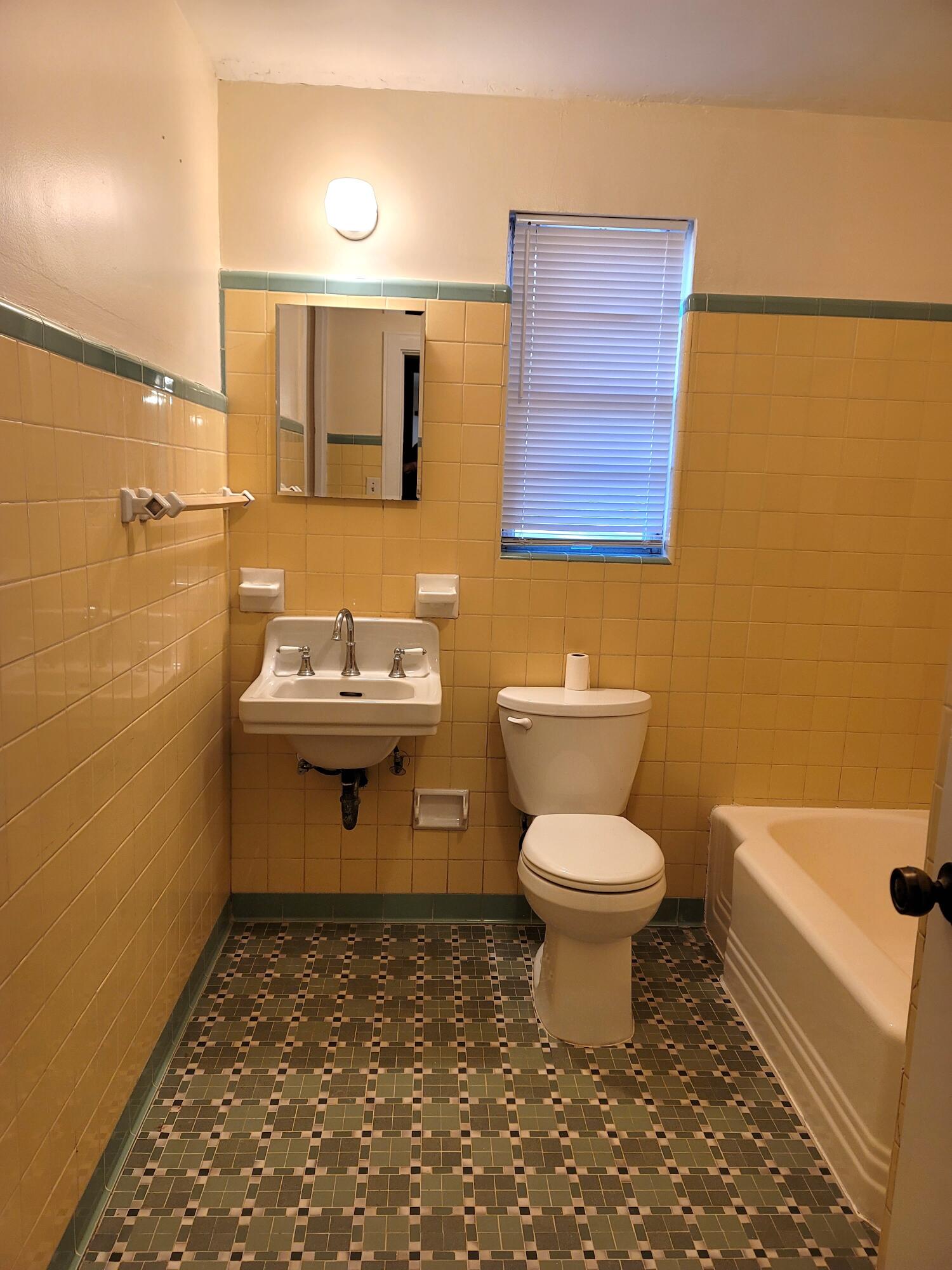 4362 West Midway Road Fort Pierce, FL 34981 - Photo 18 of 31 a bathroom with a sink a toilet and a mirror
