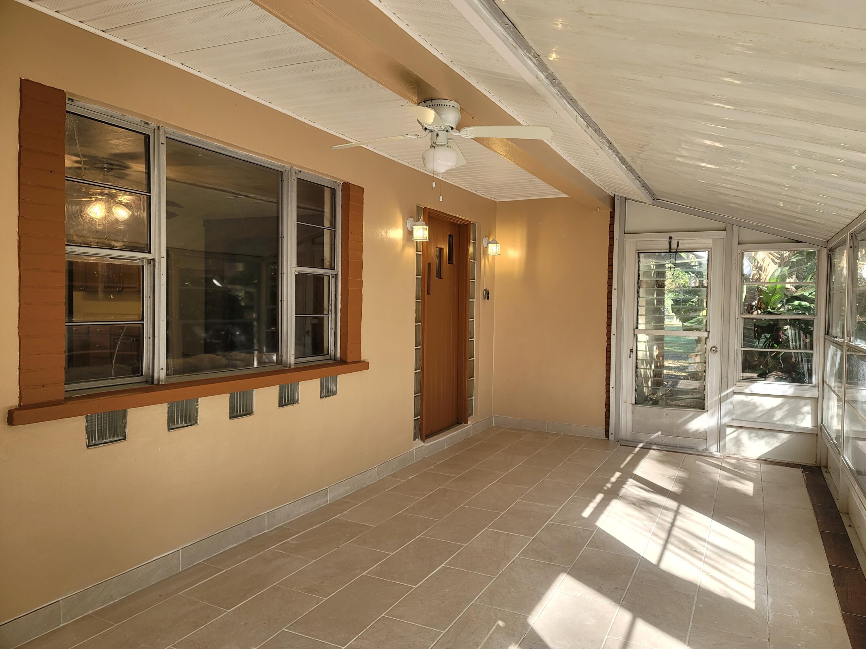 4362 West Midway Road Fort Pierce, FL 34981 - Photo 7 of 31 a view of an entryway with a chandelier