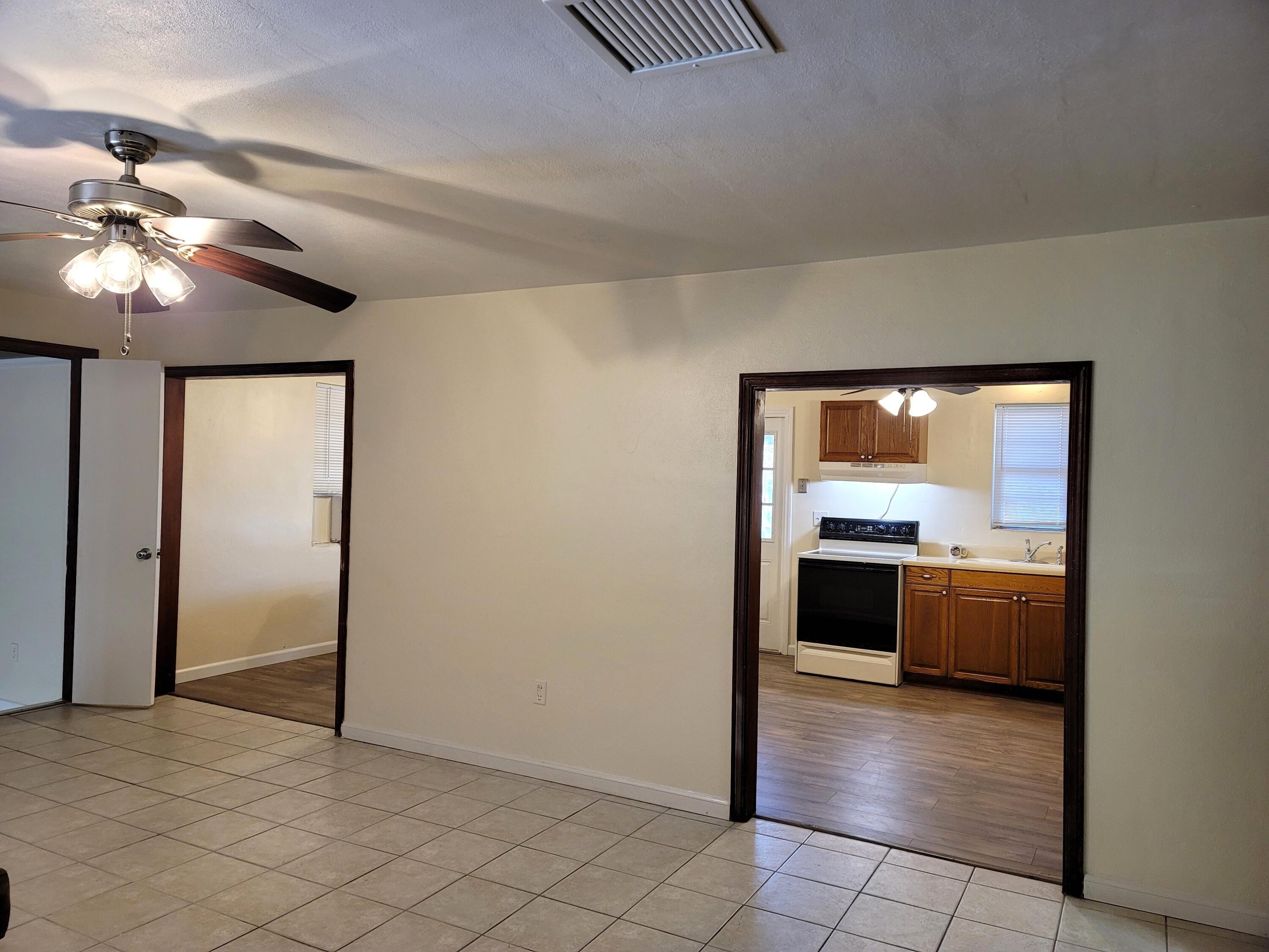 4362 West Midway Road Fort Pierce, FL 34981 - Photo 10 of 31 a view of a kitchen with a stove cabinets and chandelier