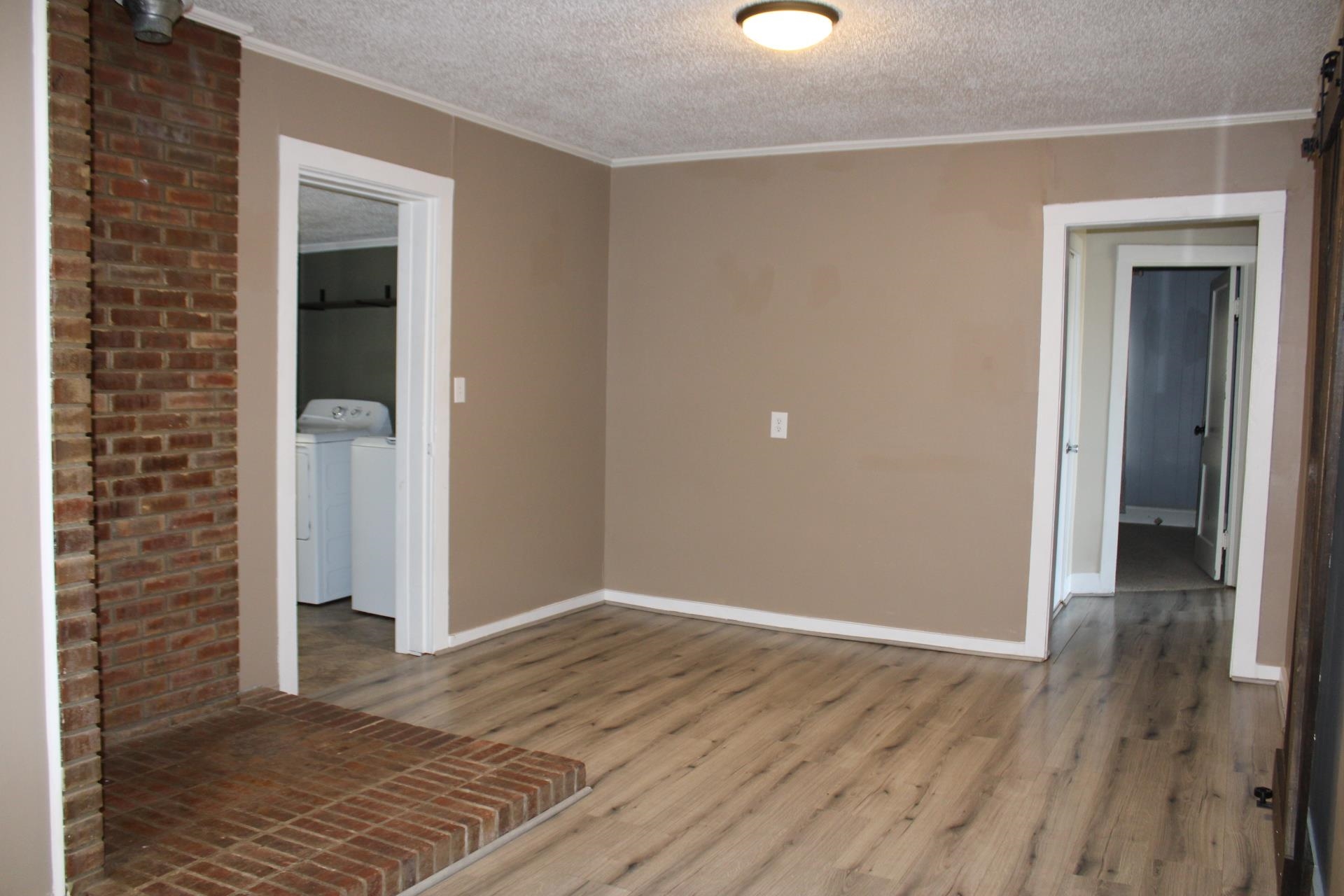 5787 Richardson Landing Road Drummonds, TN 38023 - Photo 11 of 37 a view of an empty room with wooden floor