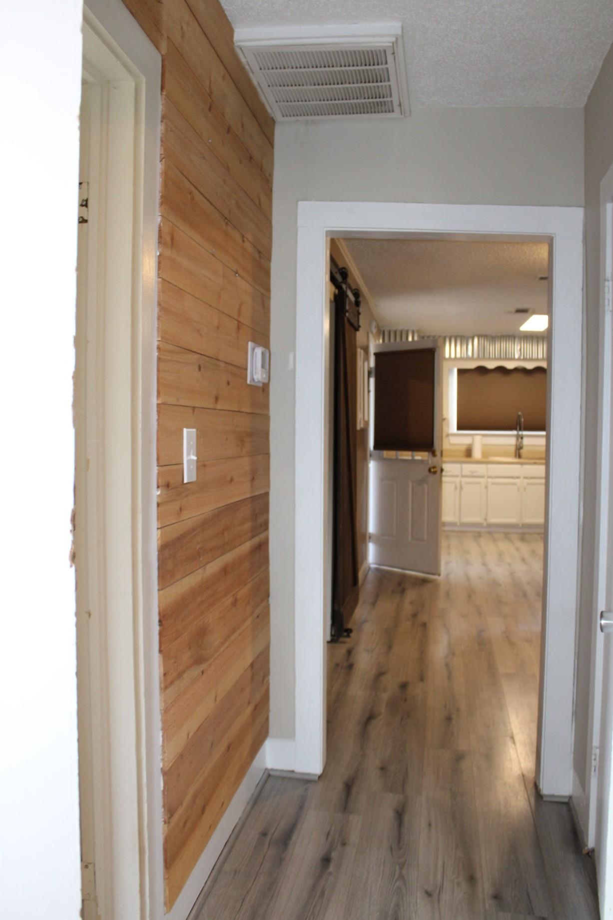 5787 Richardson Landing Road Drummonds, TN 38023 - Photo 16 of 37 a view of a hallway with wooden floor and staircase