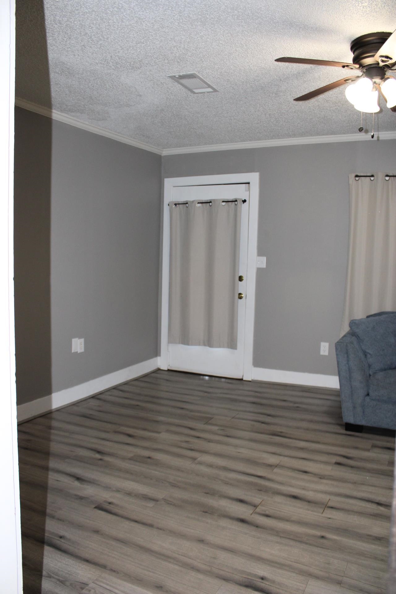 5787 Richardson Landing Road Drummonds, TN 38023 - Photo 9 of 37 a view of an empty room with wooden floor and a window