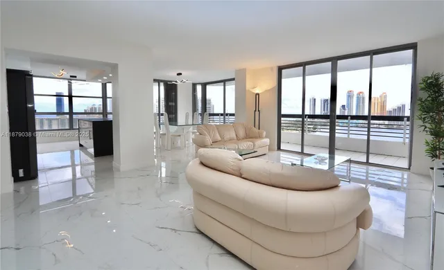 a living room with furniture and a floor to ceiling window