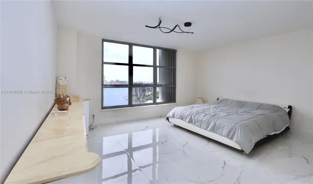 a spacious bedroom with a bed and a window