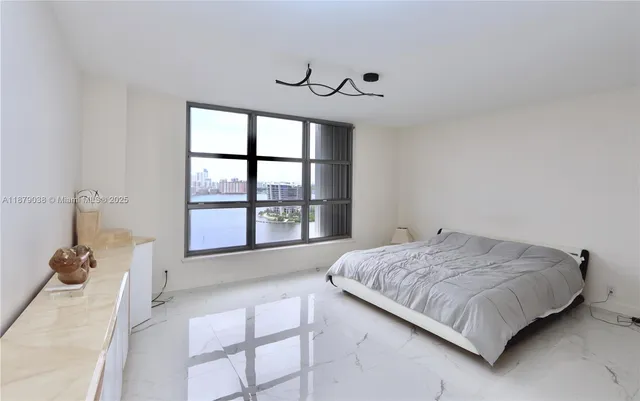 a spacious bedroom with a bed and a large window