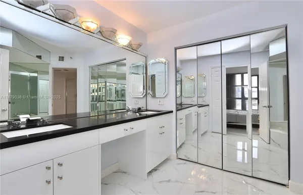 a large white kitchen with a large window