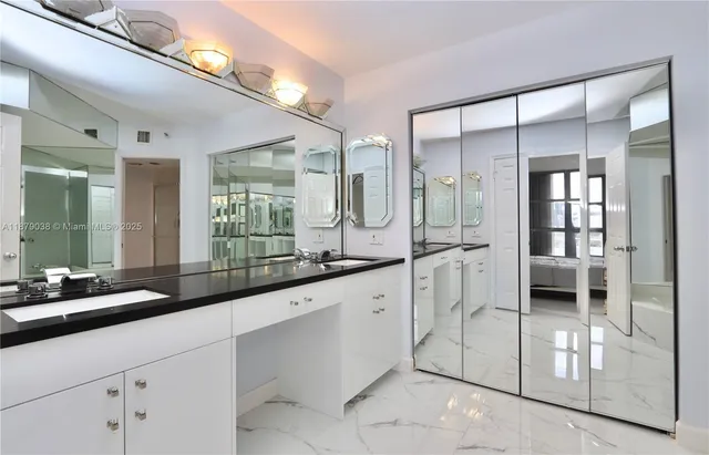 a large white kitchen with a large window