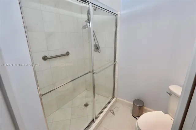 a bathroom with a shower and toilet