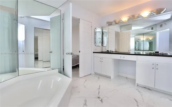 a spacious bathroom with a granite countertop sink mirror and a