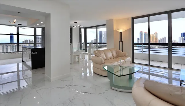 a living room with furniture and a floor to ceiling window