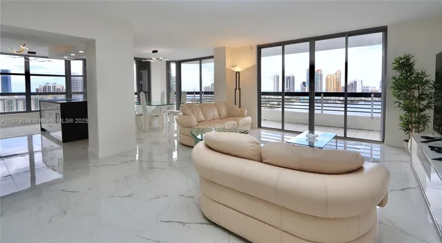 a living room with furniture and a floor to ceiling window