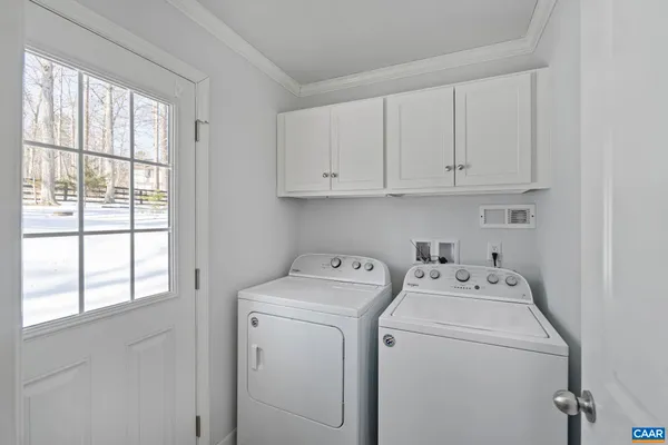 a view of storage and utility room with washer and dryer