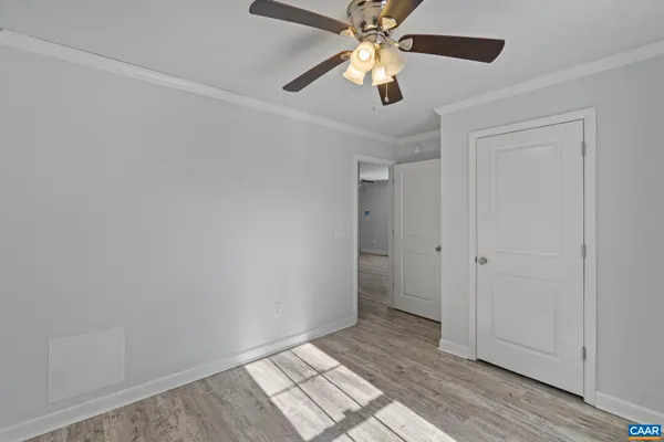 a view of an empty room and wooden floor