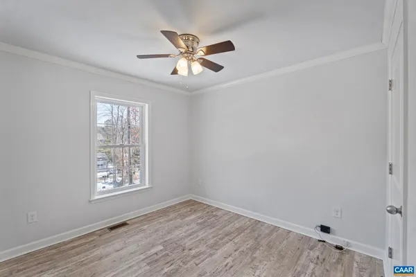 wooden floor in an empty room with a window