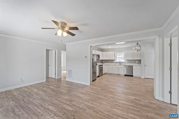 a view of a kitchen with a sink and wooden cabinet