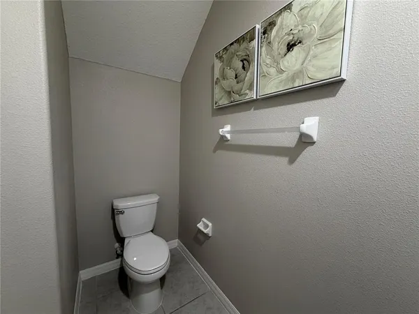 a white toilet sitting next to a bathroom sink