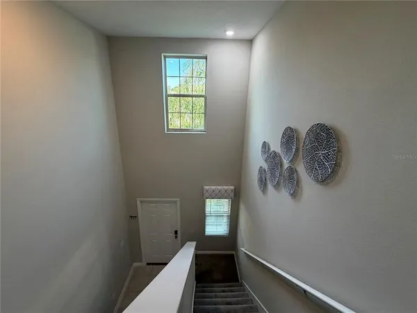 a view of a hallway with windows