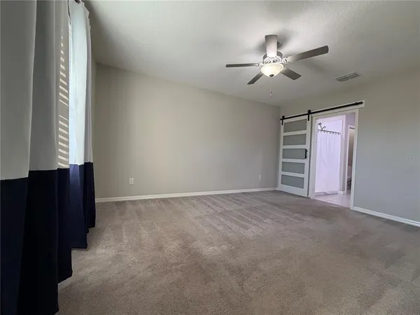 a view of an empty room with a window