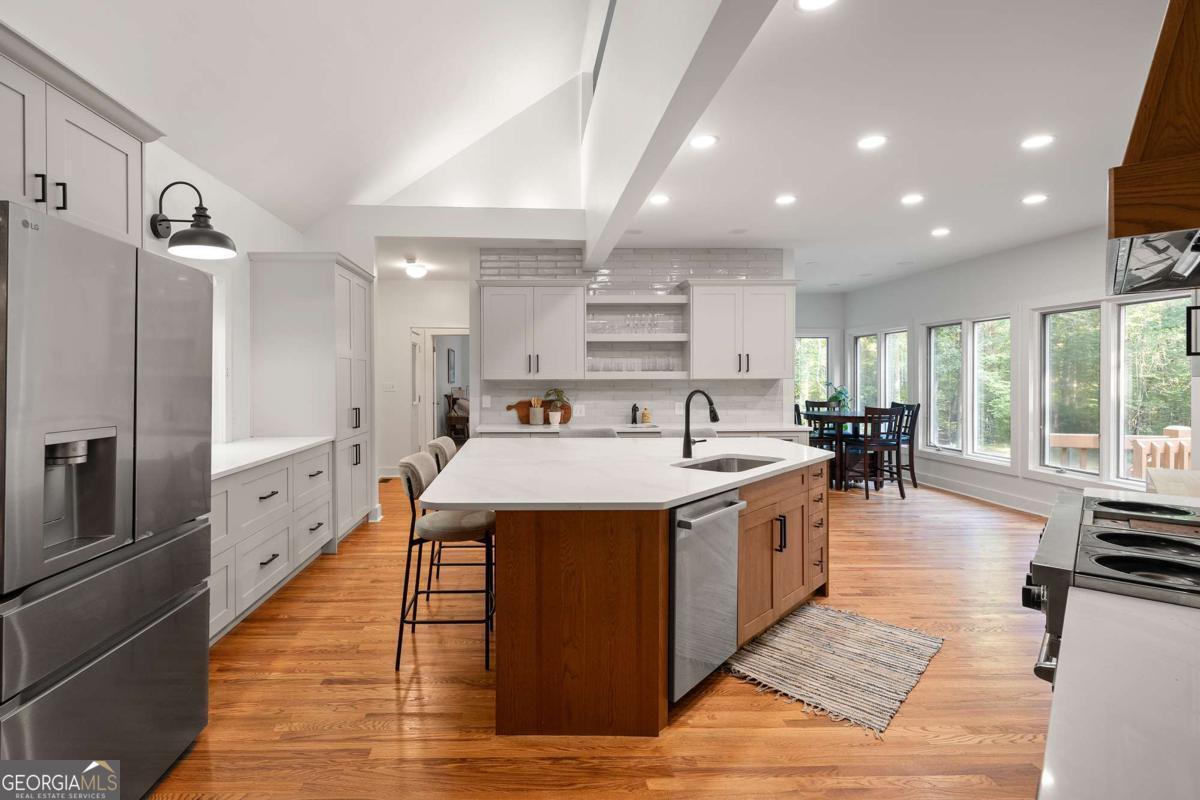134 Tanner Bluff Athens, GA 30606 - Photo 12 of 45 a large kitchen with stainless steel appliances granite countertop a large center island and a stove