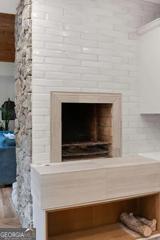 a living room with a fireplace and a potted plant