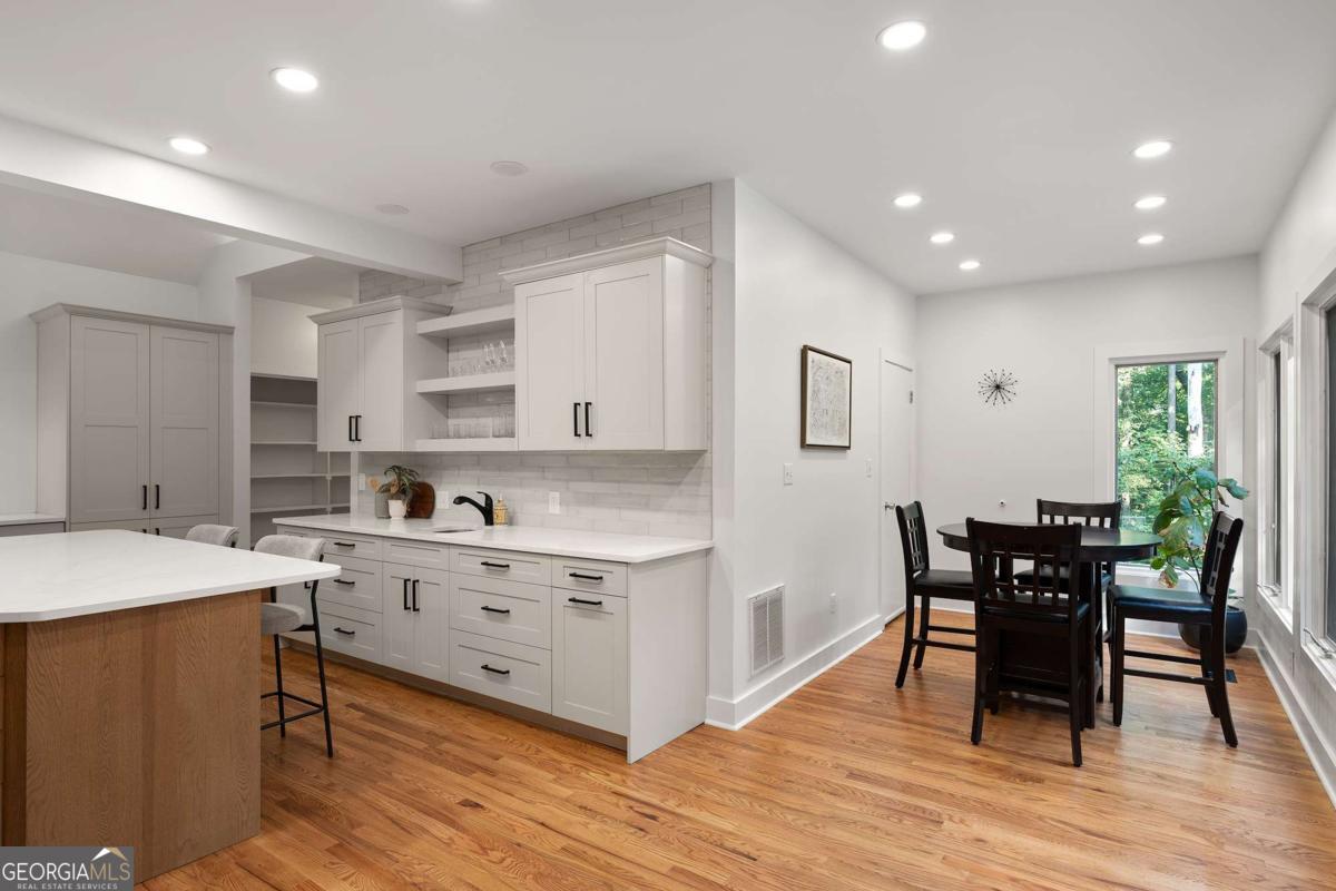 134 Tanner Bluff Athens, GA 30606 - Photo 16 of 45 a kitchen with stainless steel appliances granite countertop a stove a sink a refrigerator and a dining table with wooden floor