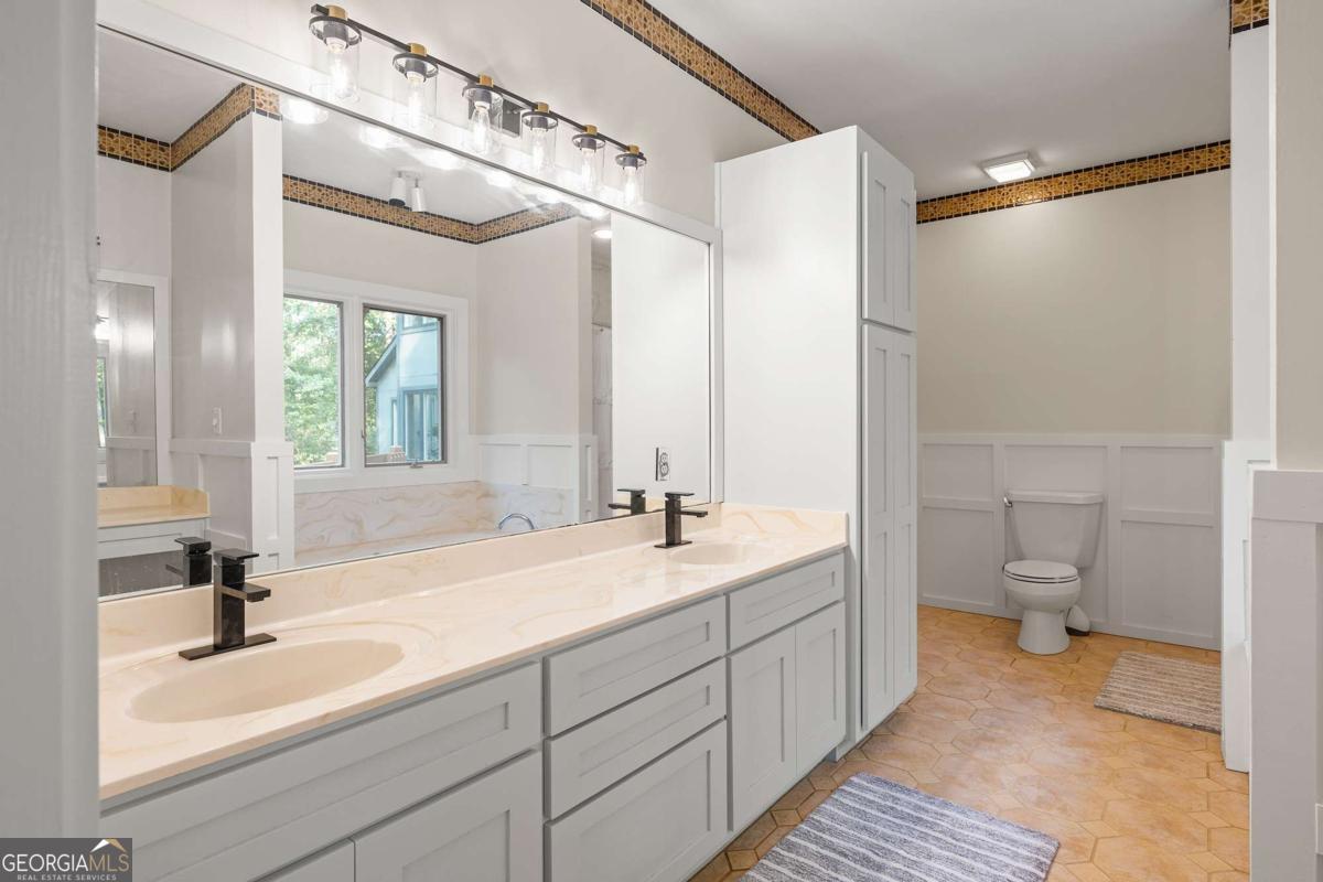 134 Tanner Bluff Athens, GA 30606 - Photo 30 of 45 a bathroom with a double vanity sink and mirror with toilet