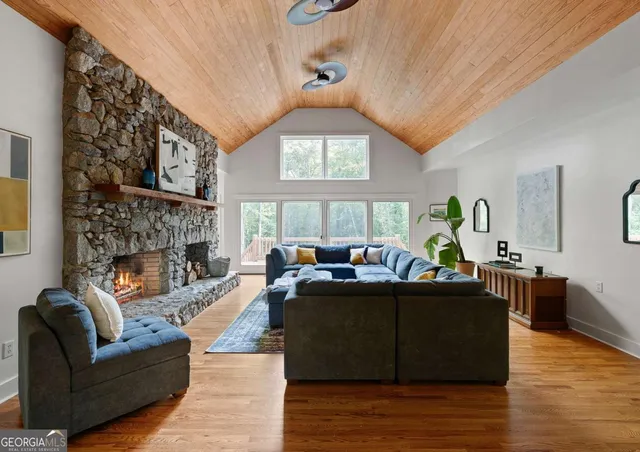 a living room with fireplace furniture and a window