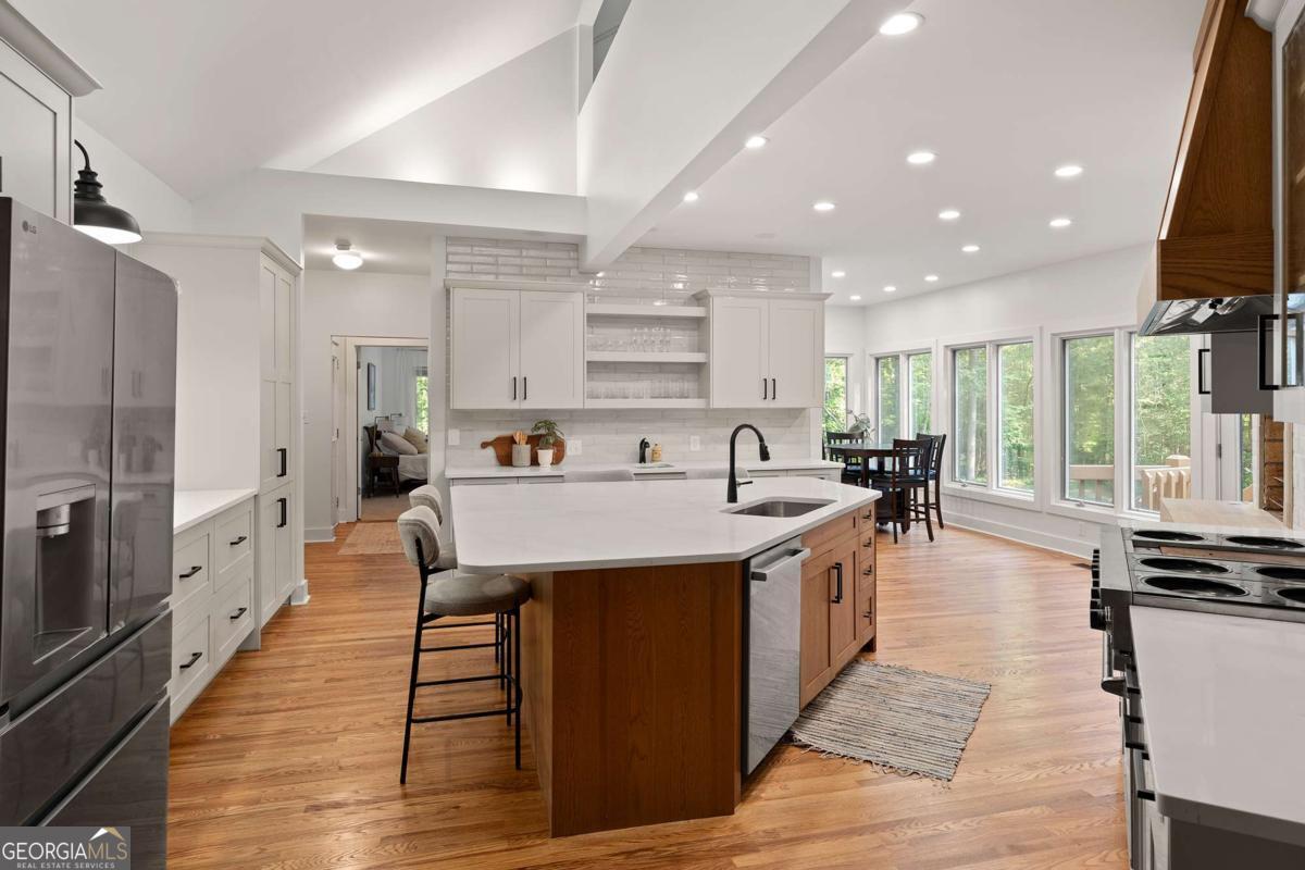134 Tanner Bluff Athens, GA 30606 - Photo 10 of 45 a large kitchen with stainless steel appliances a lot of counter space and a wooden floor