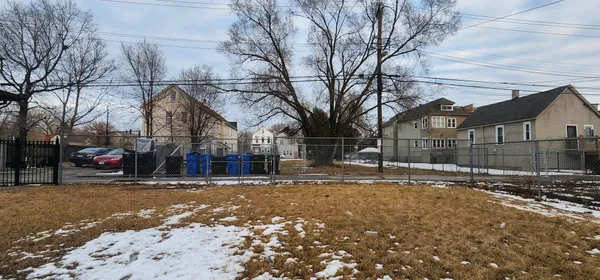 a view of street with a white house