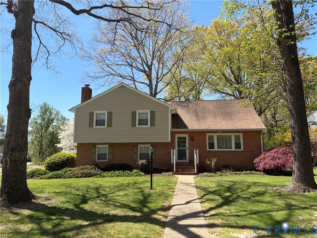 8001 Moorefield Road Henrico, VA 23229 - Photo 1 of 1 a front view of a house with a garden
