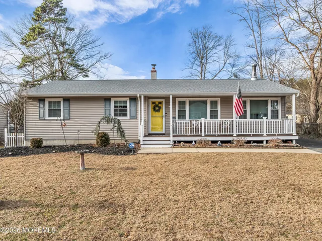 a backyard of a house with table and chairs