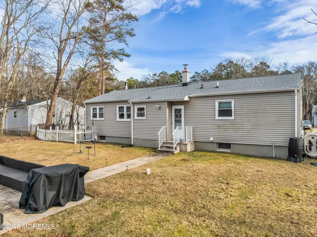 a view of a house with swimming pool and sitting area