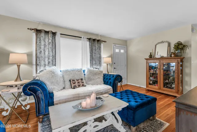 a living room with furniture a rug and a lamp