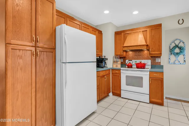 a kitchen with stainless steel appliances a refrigerator sink and cabinets