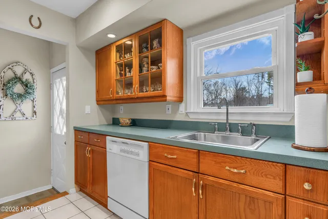 a kitchen with granite countertop stainless steel appliances a sink and a window