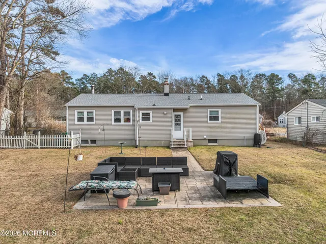 a view of a house with swimming pool and sitting area