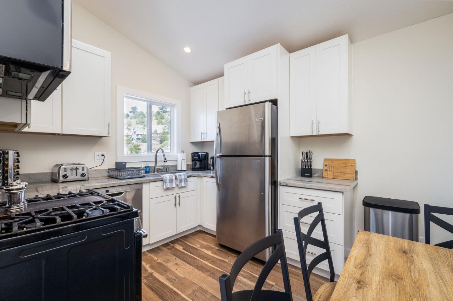472 Lewis Lane Pacifica, CA 94044 - Photo 14 of 23 a kitchen with a stove a refrigerator and cabinets