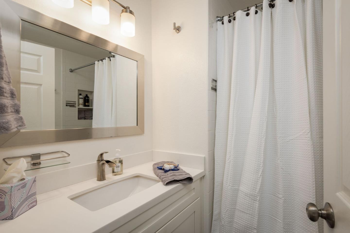 472 Lewis Lane Pacifica, CA 94044 - Photo 16 of 23 a bathroom with a sink vanity and a mirror