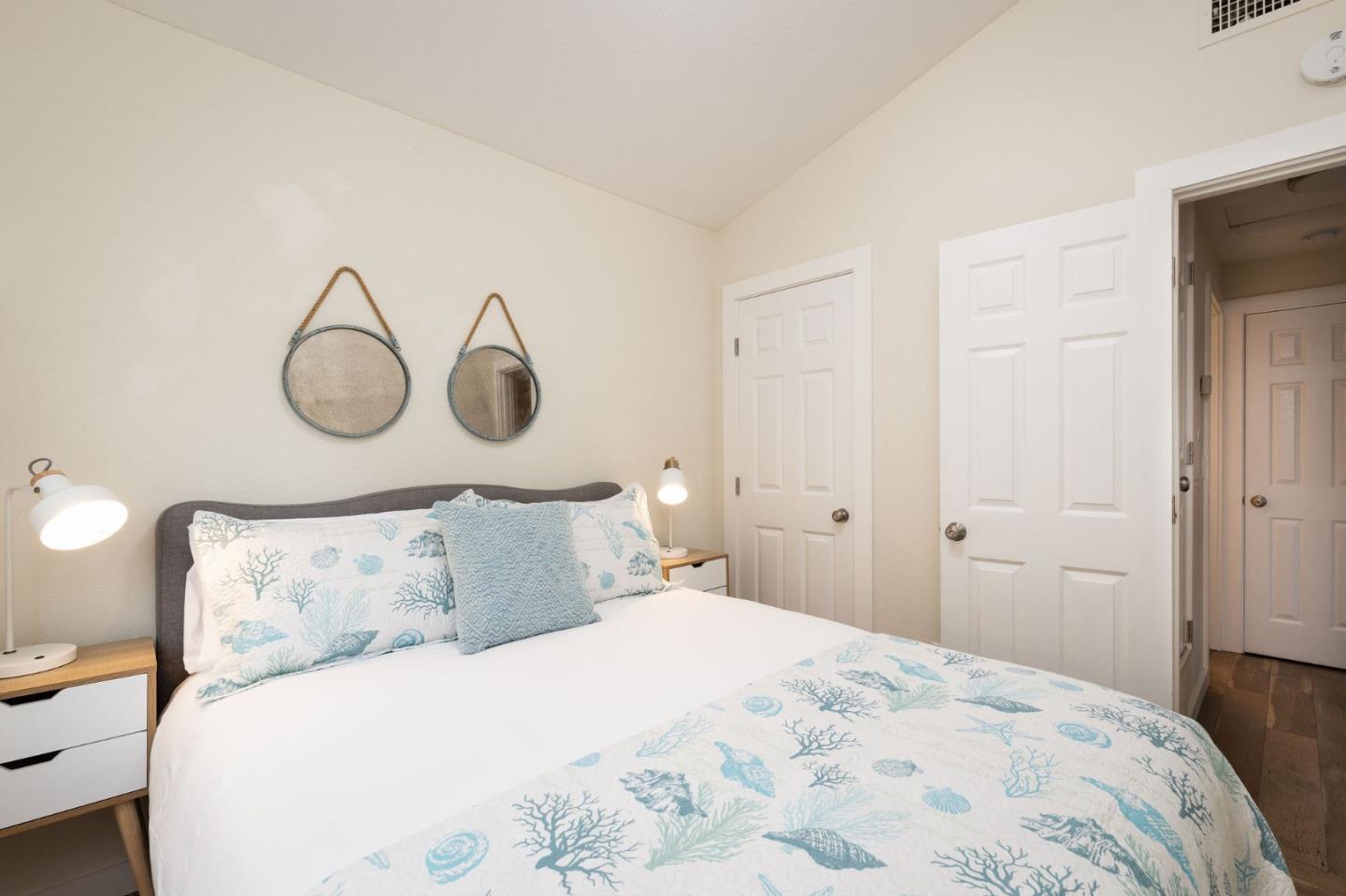 472 Lewis Lane Pacifica, CA 94044 - Photo 7 of 23 a bedroom with a bed and lamps