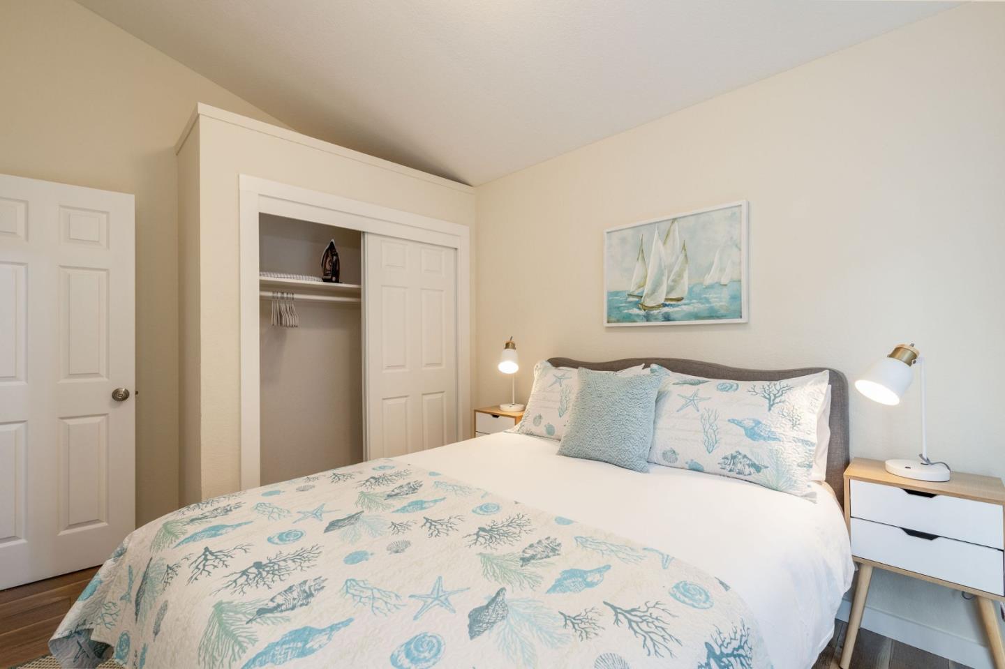 472 Lewis Lane Pacifica, CA 94044 - Photo 9 of 23 a bedroom with a bed and painting on the wall