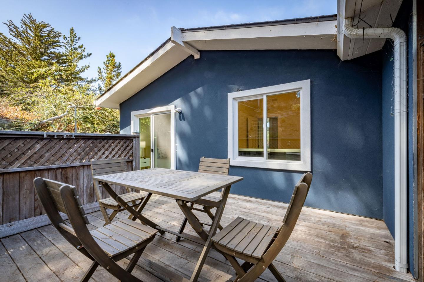 472 Lewis Lane Pacifica, CA 94044 - Photo 10 of 23 a view of a patio with table and chairs with wooden floor and bench