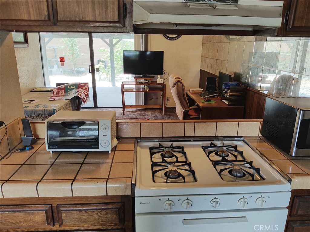 8855 Oneida Avenue Sun Valley, CA 91352 - Photo 20 of 22 a kitchen with a stove and a microwave