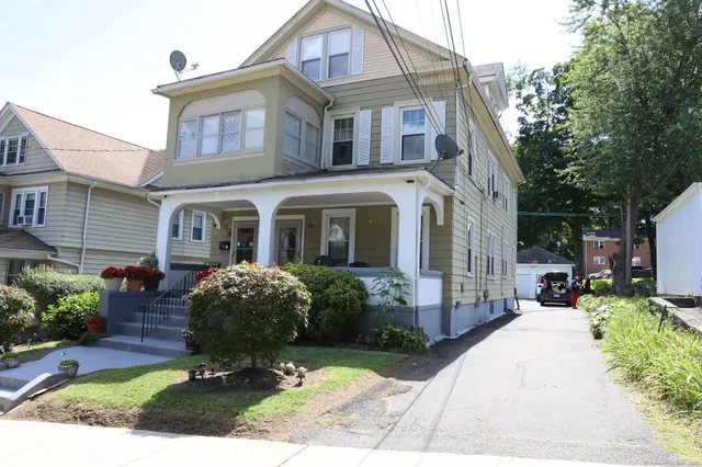 a front view of a house with garden