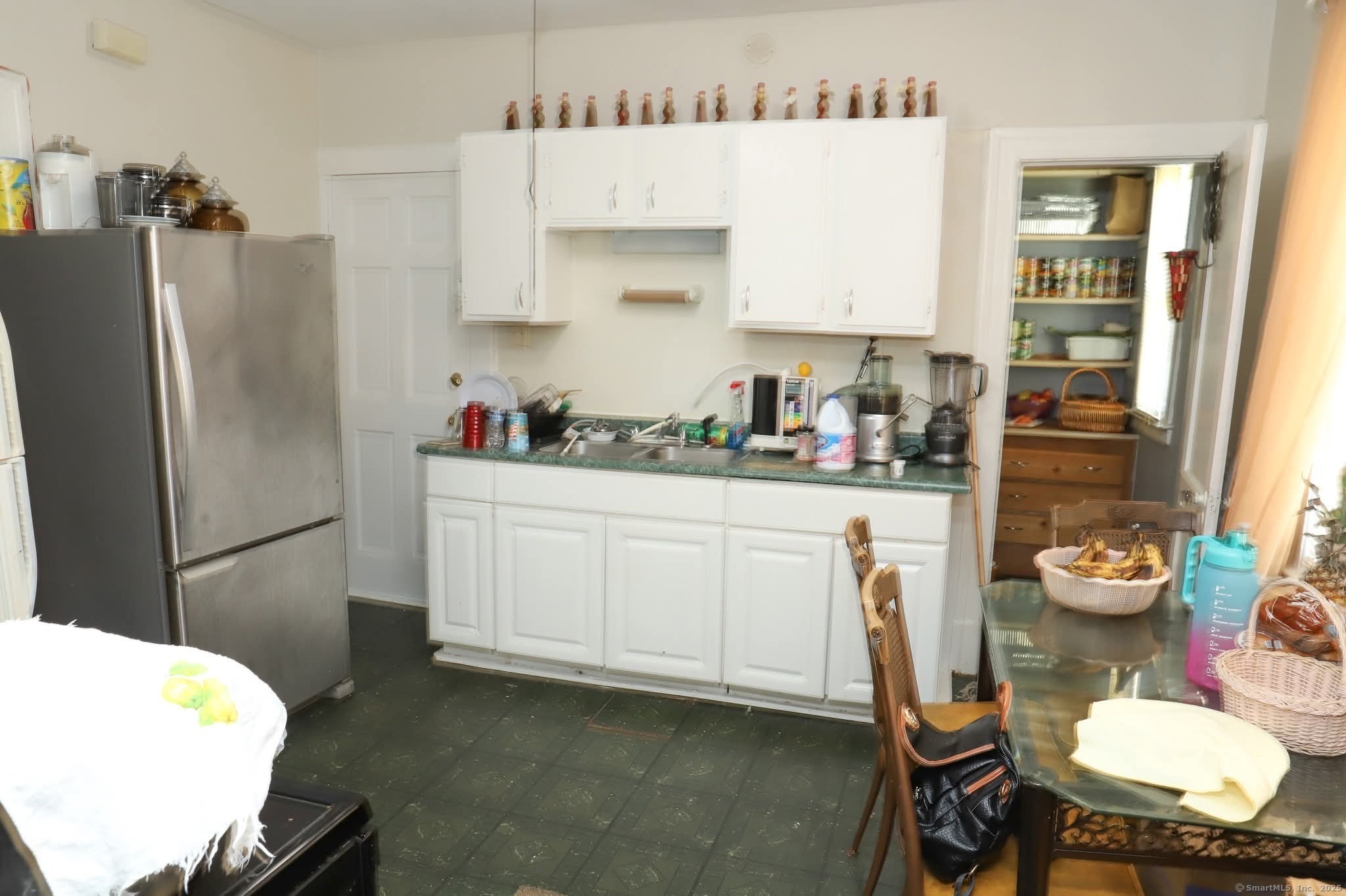 11 Pershing Street Hartford, CT 06112 - Photo 12 of 37 a kitchen with sink refrigerator and cabinets