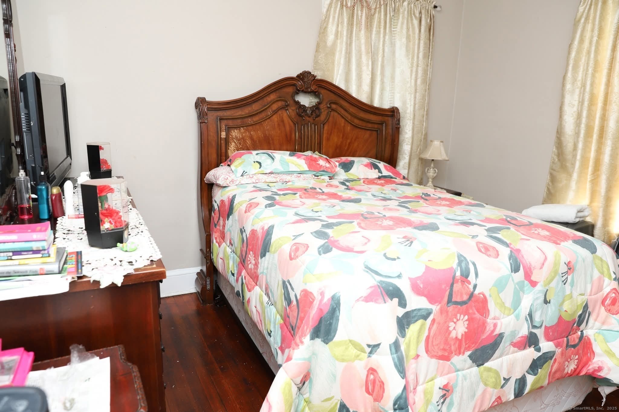 11 Pershing Street Hartford, CT 06112 - Photo 13 of 37 a bedroom with a bed and a flat tv screen on the dresser